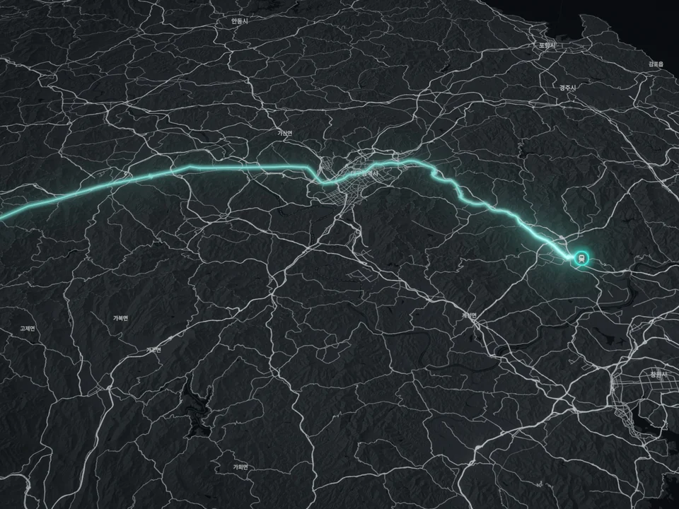 Film frame: a teal route traced along the railway towards Busan over shaded terrain.